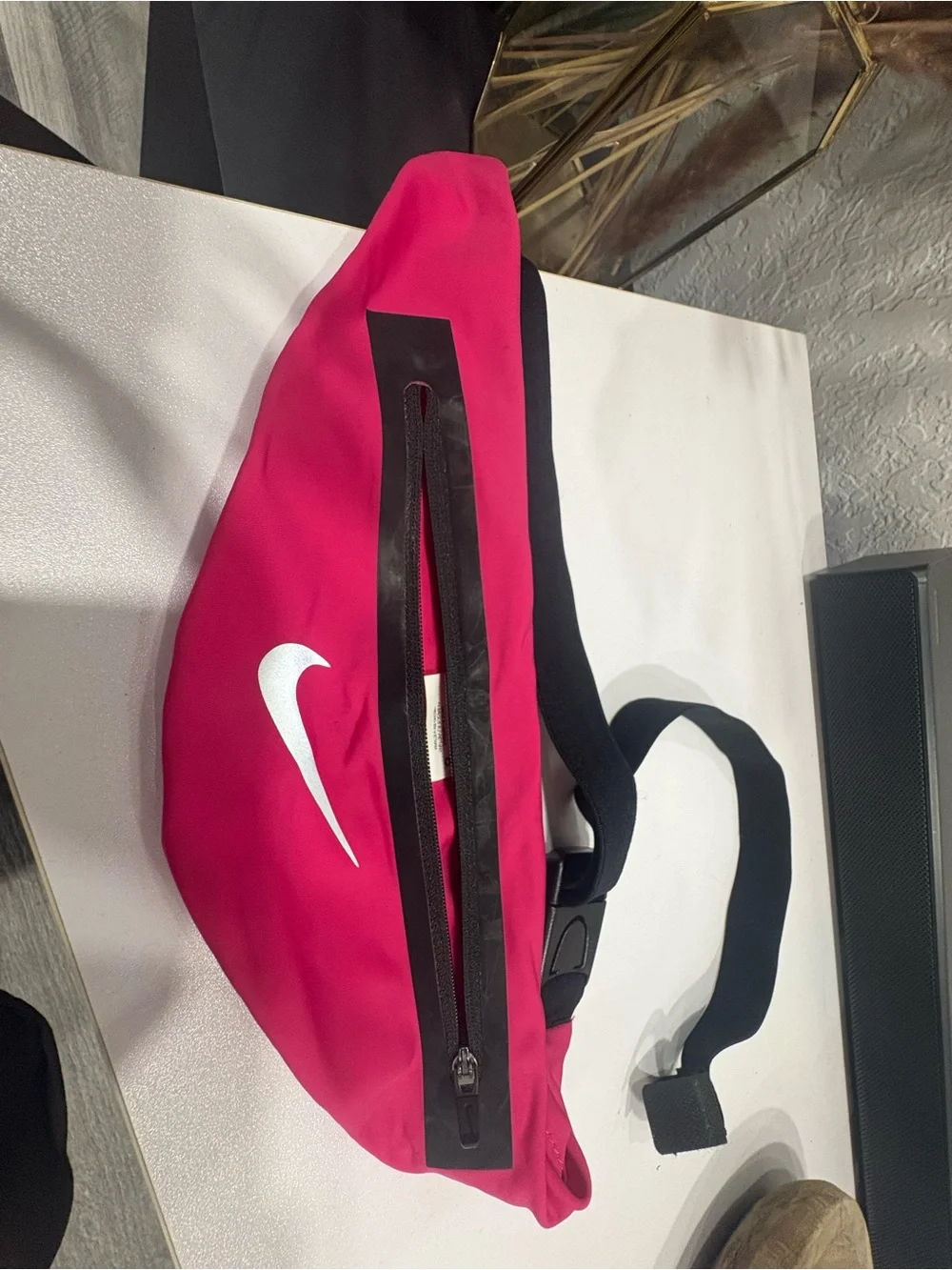 Nike pink waist pack with white Swoosh and black strap